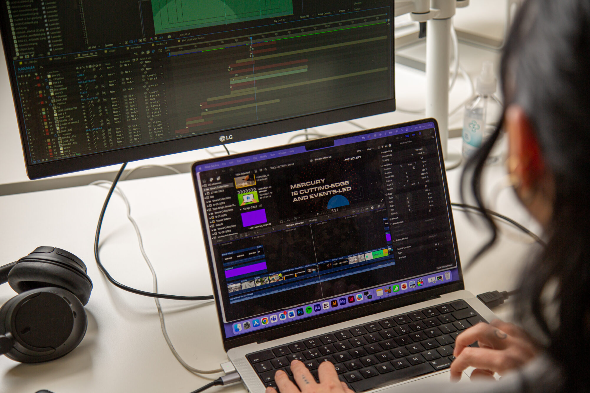 Over the shoulder shot of team member working on video production on a laptop