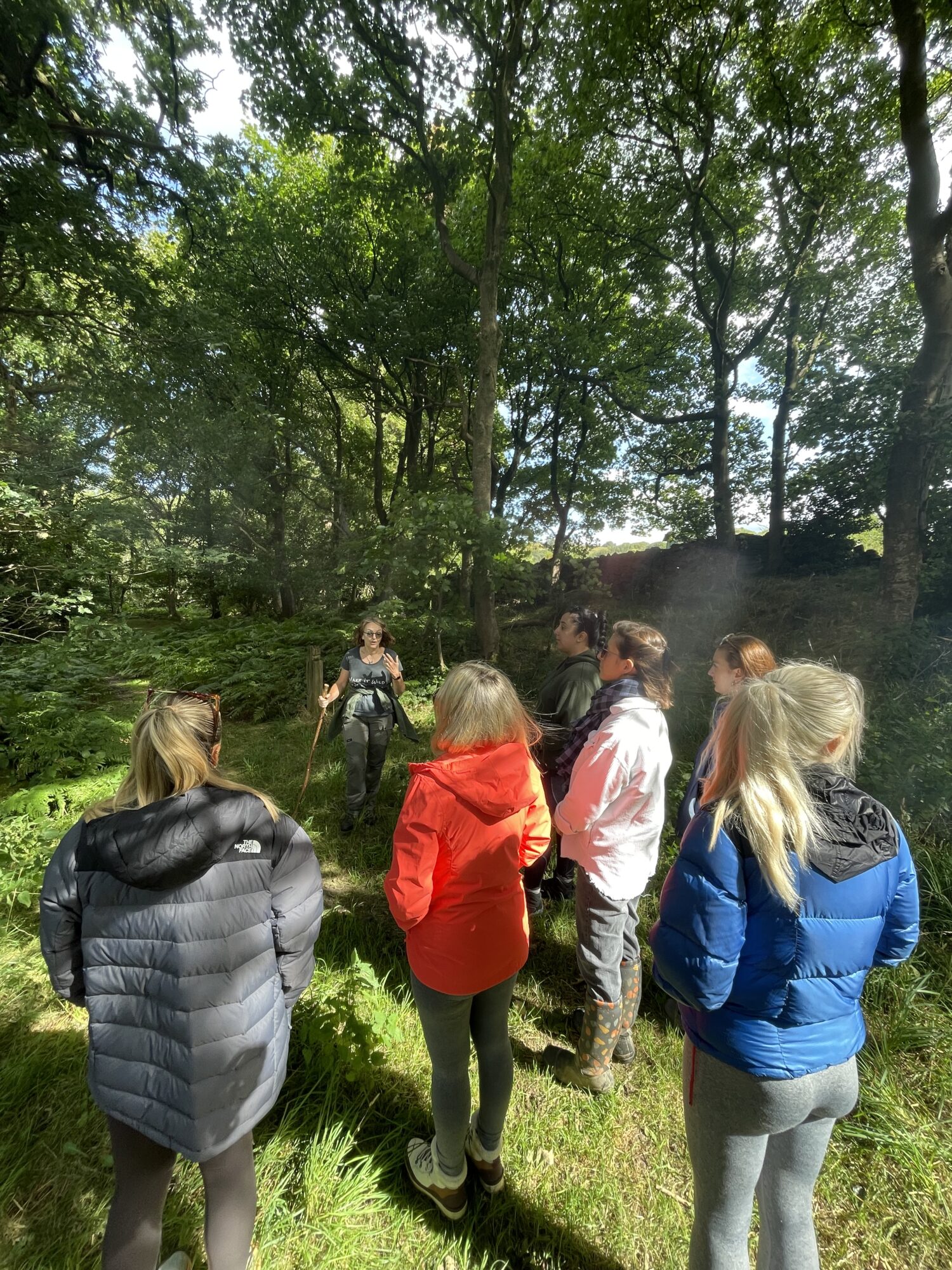 6 members of the Halston B2B team getting a tour of Bank Wood's ancient woodlands from a Make It Wild team member