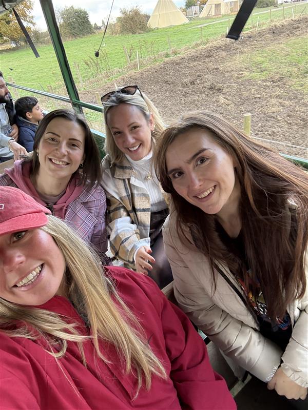A selfie of four members of the Halston B2B team on a tractor trailer